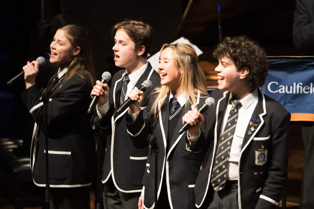 High school students singing together on stage