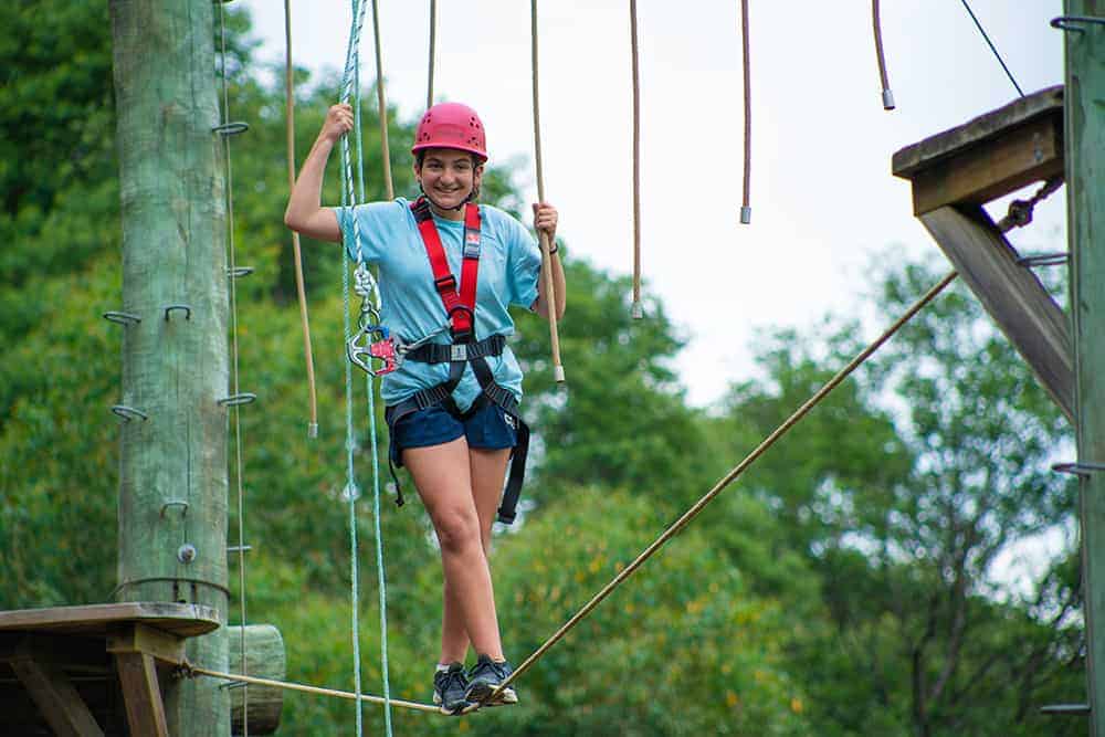 High school student exploring the ropes course as part of the education outdoors program in Yarra Junction
