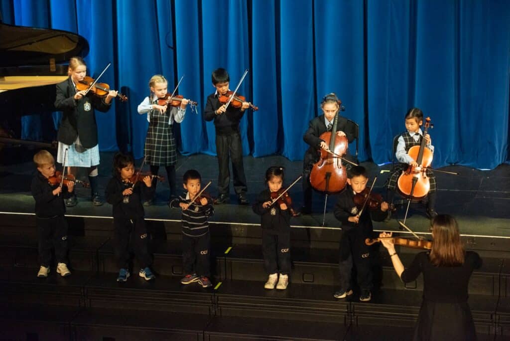 ELC students performing music on stage